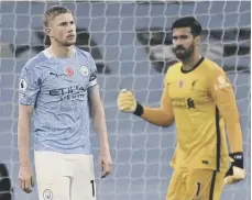  ??  ?? 0 Liverpool goalkeeper Alisson reacts after Manchester City midfielder Kevin De Bruyne missed a first-half penalty.