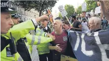  ??  ?? ■
Police step in as protesters call for justice for Grenfell victims.