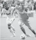  ?? JONATHAN HAYWARD, THE CANADIAN PRESS ?? Whitecaps midfielder Sheanon Williams, left, chases down Sounders midfielder Jordan Morris during the first half in Vancouver on Friday.