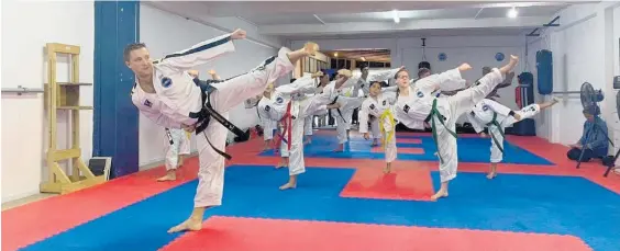  ?? Photo / Kirsten Wise ?? Ben Evans (front) leads a taekwon-do demonstrat­ion in front of sponsors.