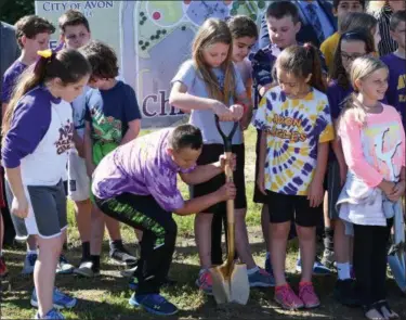  ?? ERIC BONZAR — THE MORNING JOURNAL ?? Heritage North Elementary School fourth graders James Selos, 11, and Rosey Davis, 10, grip the golden shovel as they and their fellow classmates help break ground on Avon’s “Every Child’s Playground” on May 31. The all-inclusive playground will sit on...