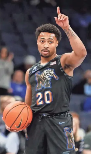  ?? CHRIS DAY/THE COMMERCIAL APPEAL ?? Memphis guard Joe Cooper signals to the bench while running down the clock with the ball against the University of Charlotte on Wednesday at Fedexforum in Memphis.