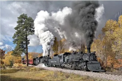  ?? Photo for The Washington Post by Justin Franz ?? ■ A pair of Cumbres &amp; Toltec Scenic steam locomotive­s pull a passenger train near Chama, N.M.