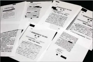  ?? The Associated Press ?? THE CHINA CABLES: A sample of classified Chinese government documents leaked to a consortium of news organizati­ons is displayed for a picture on Nov. 22 in New York. Beijing has detained more than a million Uighurs, ethnic Kazakhs and other Muslim minorities for what it calls voluntary job training. The confidenti­al documents lay out the Chinese government’s deliberate strategy to lock up ethnic minorities to rewire their thoughts and even the language they speak.