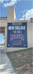  ?? SARA ENGLES ?? A sign draped on the side of a bridge near New College of Florida's campus on Tamiami Trail announces the college's acceptance into the National Associatio­n of Intercolle­giate Athletics on Monday.