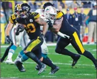  ?? The Associated Press ?? RUSHING TO SCORE: Pittsburgh Steelers running back James Conner (30) rushes for a touchdown during the second half of Monday’s game against the Miami Dolphins in Pittsburgh.