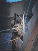  ?? ?? A 3RAR soldier provides security on a stairway during an urban assault