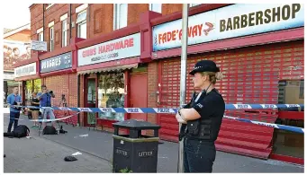  ??  ?? Cordoned off: Forjani’s barber shop in South Manchester was raided yesterday