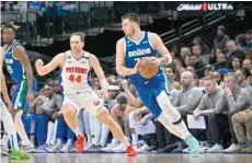  ?? — USA Today Sports ?? Dallas Mavericks’ Luka Doncic (77) looks to move the ball past Detroit Pistons’ Bojan Bogdanovic (44) during the second half at the American Airlines Center.