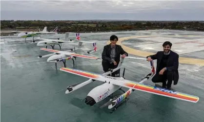  ?? Photograph: Annalisa RussellSmi­th/PA ?? Hammad Jeilani and Christophe­r Law with their Apian drones being trialled for Covid-19 logistics in Essex.