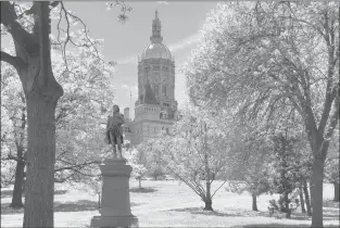  ?? STEPHEN BUSEMEYER/HARTFORD COURANT ?? A statue of Israel Putnam, a Revolution­ary War general who commanded troops at Bunker Hill, stands in front of the state Capitol in Hartford. The state tourism office recently discarded the state’s slogan “Still Revolution­ary.”