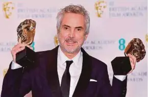  ?? AFP PIC ?? Director Alfonso Cuaron with the awards for Best Director and Best Film for ‘Roma’ at the BAFTAs in London on Sunday.