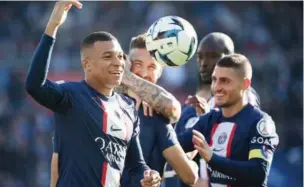  ?? (AFP) ?? Paris Saint-Germain’s French forward Kylian Mbappe (left) celebrates with teammates during the French L1 match at the Parc des Princes stadium in Paris on Sunday.