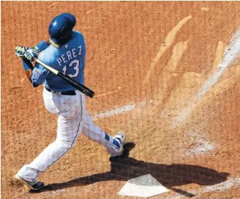  ?? THE ASSOCIATED PRESS ?? The Kansas City Royals' Salvador Perez watches his grand slam during the eighth inning of Wednesday's game against the Boston Red Sox in Kansas City, Mo. The Royals won 6-4.