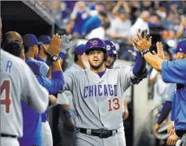  ?? Paul Sancya ?? The Associated Press Cubs third baseman David Bote accepts congratula­tions after his two-run home run in the fifth inning of an 8-2 victory Wednesday in Detroit.