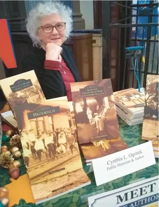  ?? SUSAN DEGRANE/DAILY SOUTHTOWN ?? Cynthia Ogorek, author of “Hegewisch,” sits with her books during a recent event at the Calumet Park Fieldhouse in Chicago.