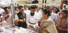  ?? Abdul Rahman/Gulf News ?? Chief guest Jiji Thomson, former Chief Secretary of Kerala, with Father Benny Mathew and other officials visit a traditiona­l food stall at the Harvest Festival on Friday.