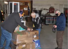  ?? Matthew Liebenberg/Prairie Post ?? Swift Current Lions Club members with a shipment of close to 5,000 old eyeglasses at Rosenau Transport, Nov. 1. From left to right, Jim Parsons (club president), Wes Vibert (eyeglass project chair), and Louis Perras.