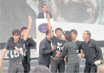  ?? PHOTO: CHANAT KATANYU ?? PUBLIC ENEMY: Student activist Pai Dao Din, centre, stages a protest against Gen Prayut Chan-o-cha in 2014.
