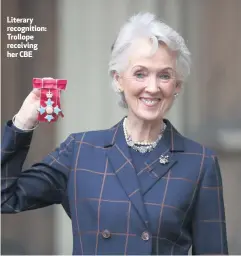  ??  ?? Literary recognitio­n: Trollope receiving her CBE