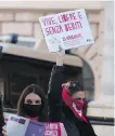  ??  ?? A woman holds up a banner reading “alive, free and without debts” during a demonstrat­ion on the Internatio­nal Day for the Eliminatio­n of Violence against Women, in Rome, Wednesday.