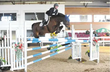  ??  ?? Chloe Reynolds lands a 1.25m class on Grenadier Volo, a promising seven-year-old by Numero Uno