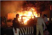  ?? (AP/Arshad Butt) ?? A police officer and rescue workers arrive at the site of bomb blast at a Serenca Hotel in Quetta, Pakistan, on Wednesday.