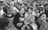  ?? PTI ?? Union Minister Smriti Irani poses for selfie during her campaign for Gujarat election in Ahmedabad on Friday.