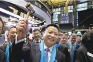  ?? Richard Drew / Associated Press ?? ZTO Express founder and CEO Meisong Lai raises a ceremonial gavel at the New York Stock Exchange.