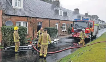  ?? 01_B09douglas­01 ?? Firefighte­rs pump out a drain that was backed up with water.