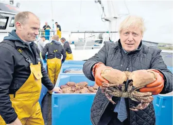  ??  ?? A union in sickness and in health: Boris Johnson holds a crab during a visit to Copland Dock in Orkney last week