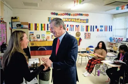  ?? PHOTOS BY ANDREW CRAFT/THE FAYETTEVIL­LE OBSERVER ?? Gov. Roy Cooper shakes hands with Spanish teacher Gina Saavedra while touring E.E. Smith High School on Tuesday.