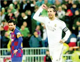  ?? AP ?? Real Madrid’s Sergio Ramos celebrates as he runs past Barcelona’s Lionel Messi during the Spanish La Liga match between Real Madrid and Barcelona at the Santiago Bernabeu stadium in Madrid, Spain, Sunday, March 1, 2020.