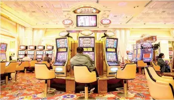  ?? — AFP photo ?? Falling internatio­nal travel, property closures and the ongoing social distancing measures will keep the gaming sector’s prospects weak until at least 2021.