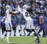  ?? ROB CARR — GETTY IMAGES ?? Raiders safety Reggie Nelson intercepts a pass in Sunday’s 34-17loss to the Baltimore Ravens. Oakland is now 2-9.