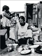  ??  ?? Life at the Margins: An Indian woman scrubbing dishes.