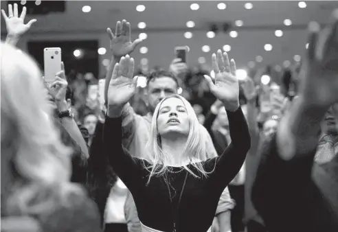  ?? JIM WATSON/GETTY-AFP ?? Supporters pray as then-President Donald Trump speaks during an “Evangelica­ls for Trump” event on Jan. 3, 2020, in Miami.