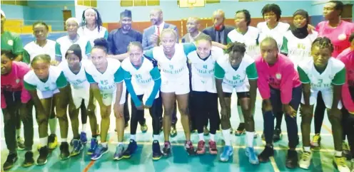  ??  ?? Minister of Sports, Sunday Dare and president of the Nigeria Handball Federation, Samuel Ocheho in a group photograph with players of the female national team when the minister visited their camp recently