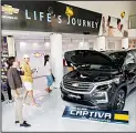  ??  ?? Prospect buyers study Chevrolet automobile­s at a dealership in Bangkok, Thailand. GM announced earlier this week it was withdrawin­g from Australia, New Zealand and Thailand as part of a global overhaul of its market strategy, worrying local owners of such vehicles. (AP)
