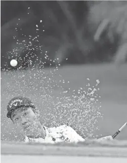  ?? KYLE TERADA/USA TODAY SPORTS ?? Kevin Na hits his bunker shot on the first hole during the final round of the Sony Open at Waialae Country Club on Sunday.