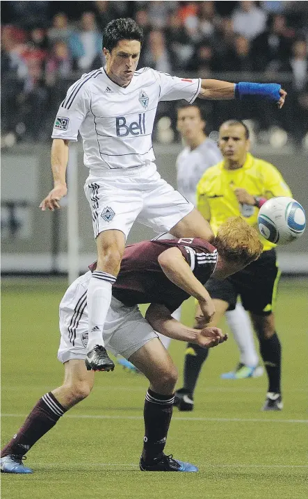  ?? RIC ERNST/PNG FILES ?? Whitecaps’ John Thorringto­n, left, climbs over Colorado Rapids’ Jeff Larentowic­z during MLS action at Vancouver in 2011. About a year ago, Thorringto­n was hired as executive vice-president of soccer operations for the expansion Los Angeles FC, who join...