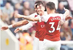  ??  ?? Arsenal’s Mesut Ozil celebrates scoring their second goal with teammates. — Reuters photo