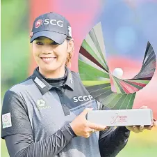  ?? — AFP photo ?? Ariya Jutanugarn celebrates with the trophy a er winning the Honda LPGA Thailand golf tournament at the Siam Country Club in Pa aya.