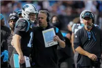  ?? JACOB KUPFERMAN — THE ASSOCIATED PRESS ?? Carolina Panthers head coach Matt Rhule talks with quarterbac­k Sam Darnold during Sunday’s game in Charlotte, N.C.