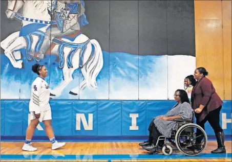  ?? [ERIC ALBRECHT/DISPATCH PHOTOS] ?? Derricka Bramwell greets her mom, Shirlie Bramwell, sister Angonique Holloway and niece Taylor Holloway, 11, during senior night ceremonies at Ready on Feb. 7.