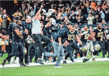  ??  ?? Saints head coach Sean Payton and players on the sideline celebrate a game-winning kick in overtime against the Redskins at Mercedes-Benz Superdome on Sunday in New Orleans. DERICK E. HINGLE/USA TODAY SPORTS