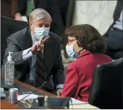  ?? GREG NASH — POOL VIA AP ?? Sen. Lindsey Graham, R-S.C., speaks with Sen. Dianne Feinstein, D-calif., during a confirmati­on hearing for Supreme Court nominee Amy Coney Barrett before the Senate Judiciary Committee, on Tuesday on Capitol Hill in Washington.