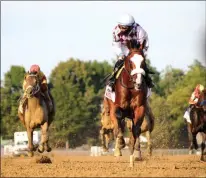  ?? PHOTO BY SPENCER TULIS, SPECIAL TO THE PINK SHEET ?? Tiz the Law takes the lead during the Travers Stakes on August 8, 2020.