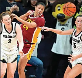  ?? DAVID ZALUBOWSKI / AP ?? USC forward Kaitlyn Davis, center, battles for control of a loose ball with Colorado guards Frida Formann (3) and Kindyll Wetta in the second half of Sunday’s game in Boulder, Colo.