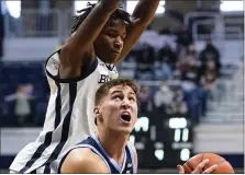  ?? MICHAEL CONROY — THE ASSOCIATED PRESSV ?? Villanova guard Collin Gillespie looks to shoot under Butler guard Chuck Harris in the first half of a game between the teams Sunday in Indianapol­is.